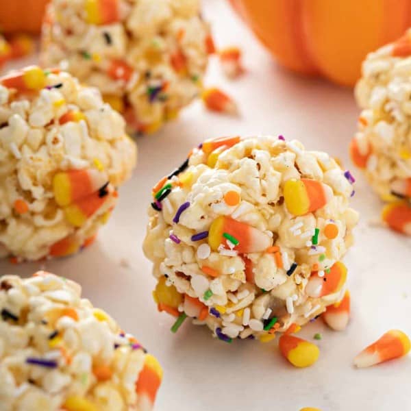 Close up of Halloween popcorn balls scattered on a marble countertop