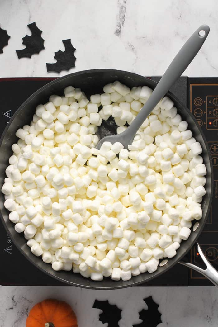 Spatula stirring marshmallows in a saucepan
