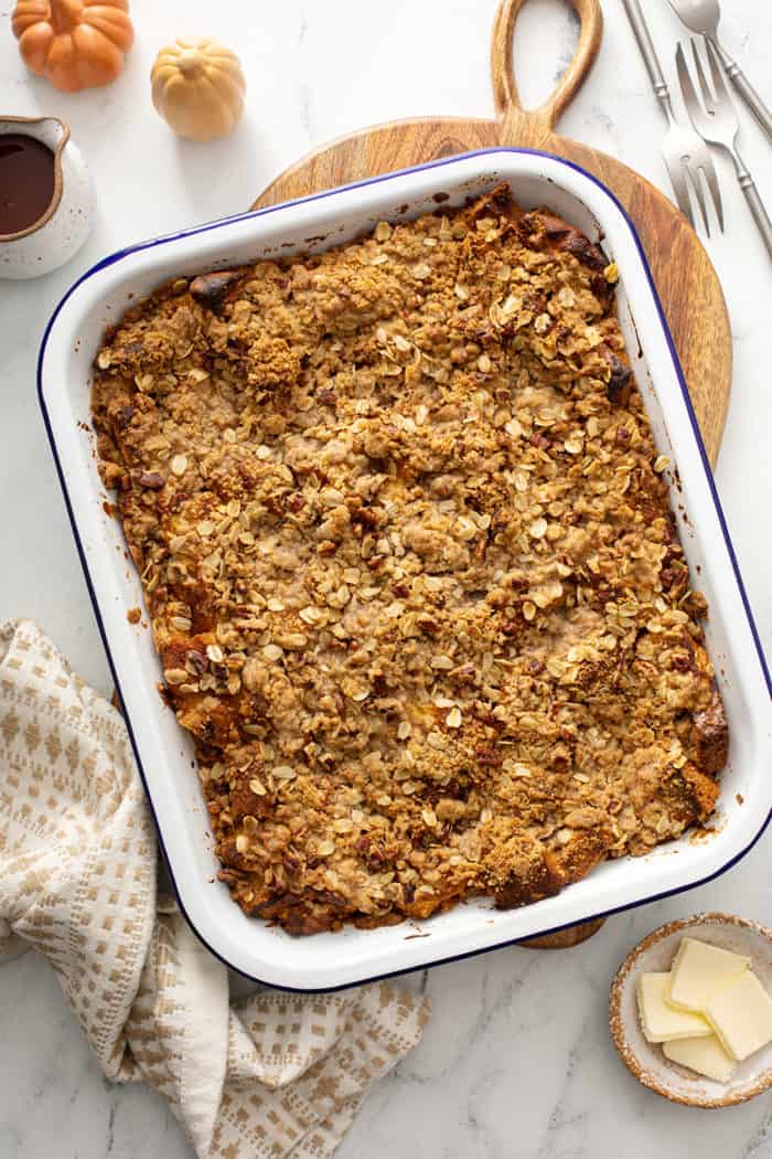 Baked pumpkin french toast casserole in a white baking dish
