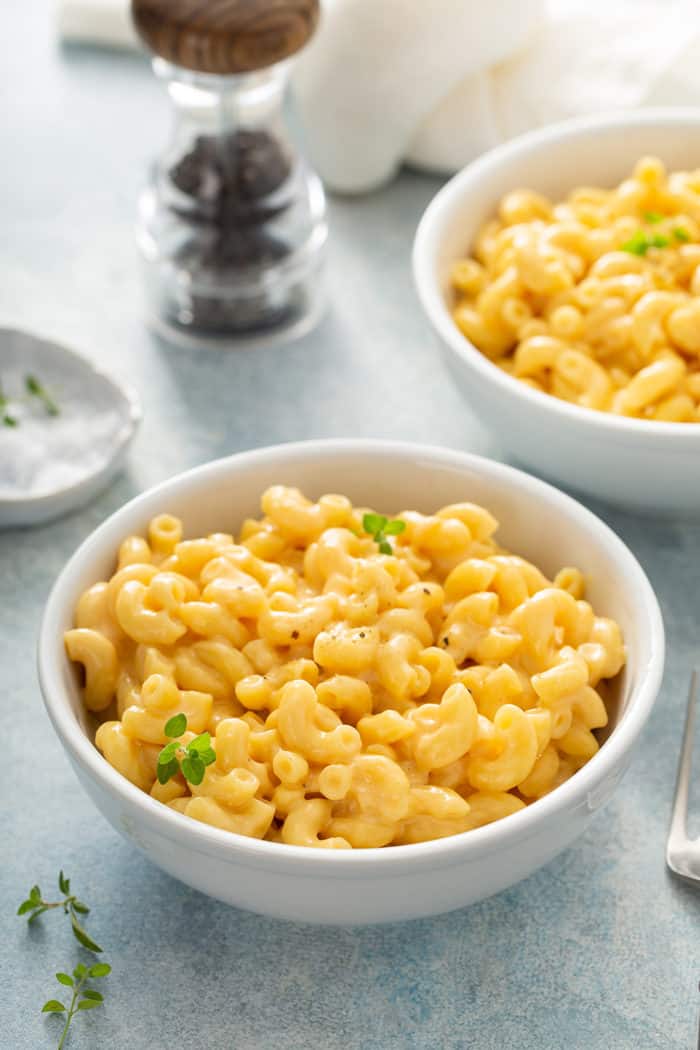 Two white bowls filled with creamy one pot macaroni and cheese