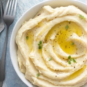 Close up of garlic mashed potatoes in a white serving bowl
