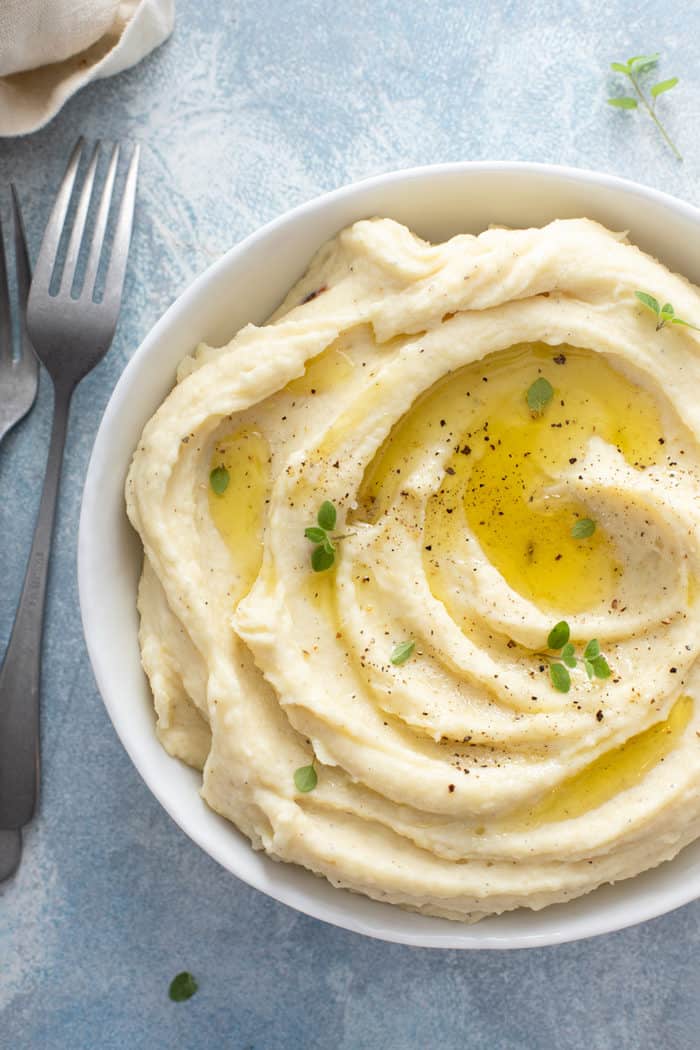 Close up of garlic mashed potatoes in a white serving bowl