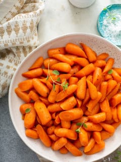 White bowl filled with honey glazed carrots