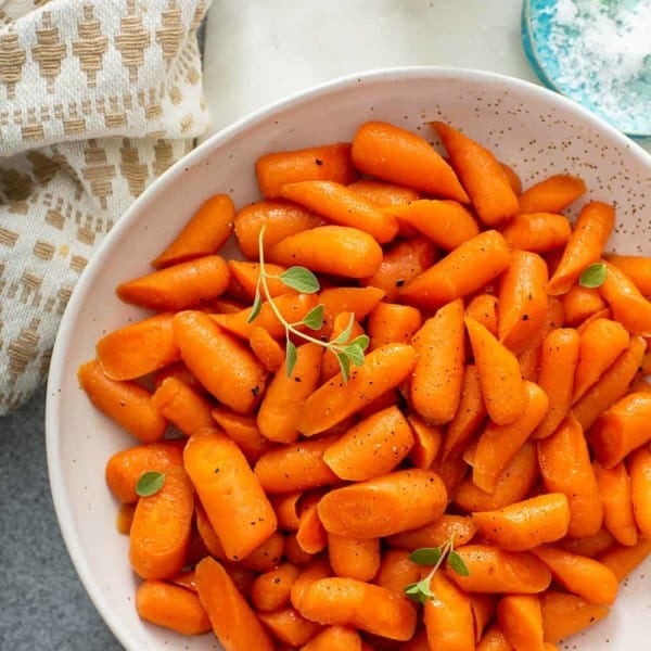 White bowl filled with honey glazed carrots