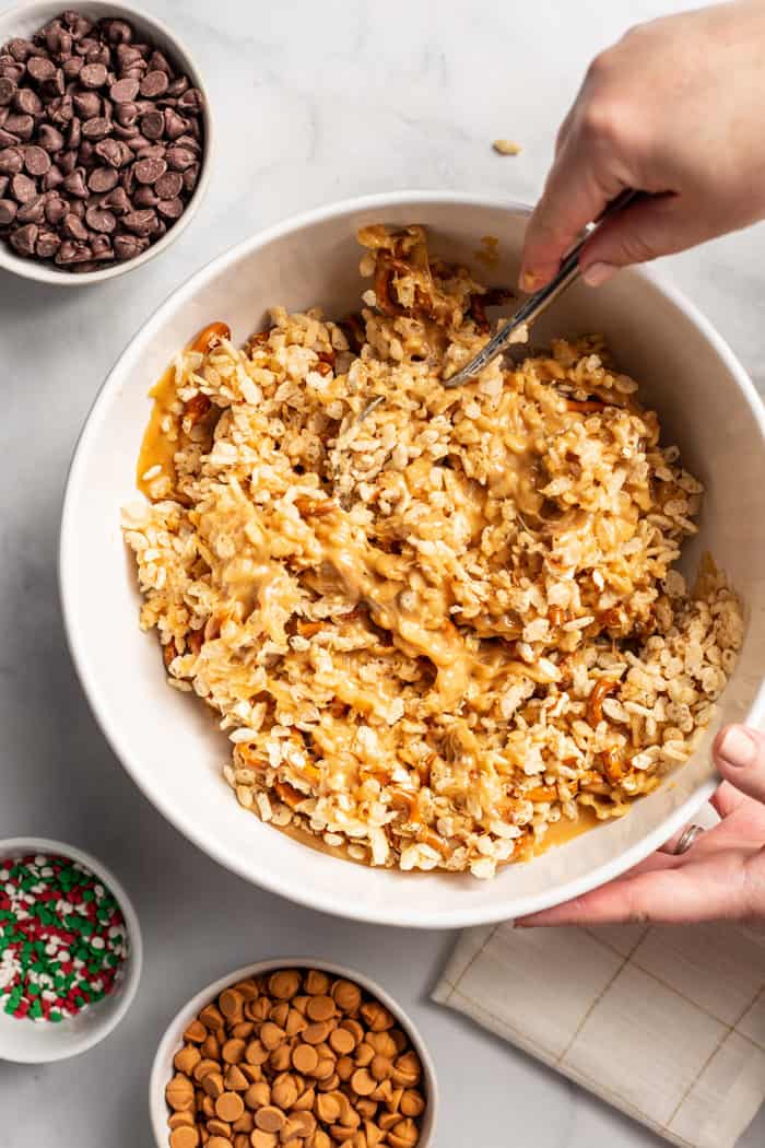 Peanut butter pretzel bar base being mixed together in a white mixing bowl