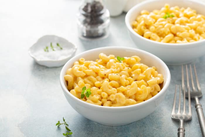 White bowl of one pot mac and cheese set on a gray countertop