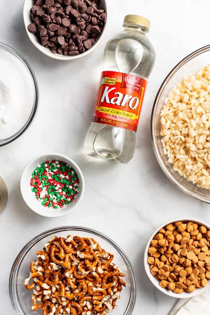 Ingredients for peanut butter pretzel bars arranged on a marble countertop