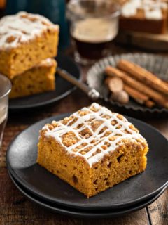 Piece of pumpkin coffee cake on a black plate