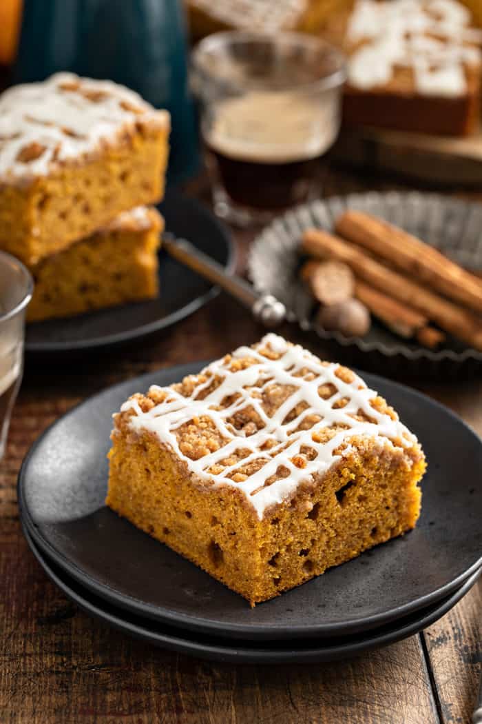 Piece of pumpkin coffee cake on a black plate