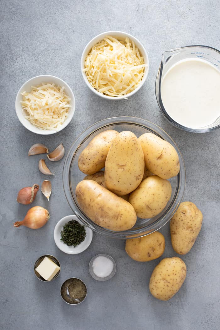 Potato gratin ingredients arranged on a gray countertop