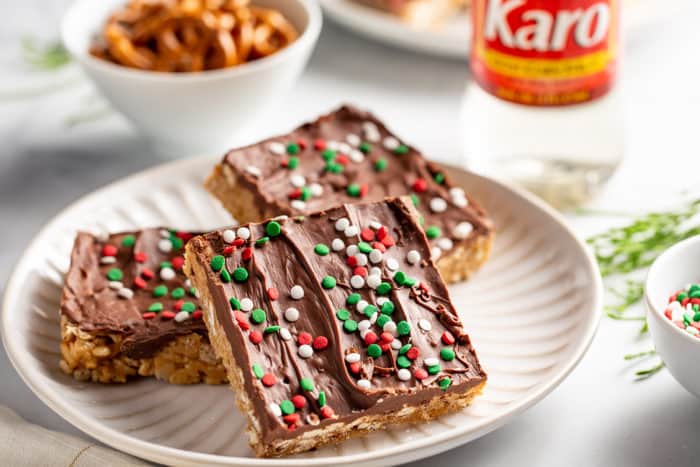 Three peanut butter pretzel bars on a white plate