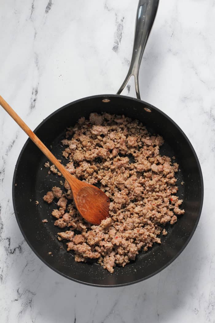 Cooked and crumbled breakfast sausage in a black skillet