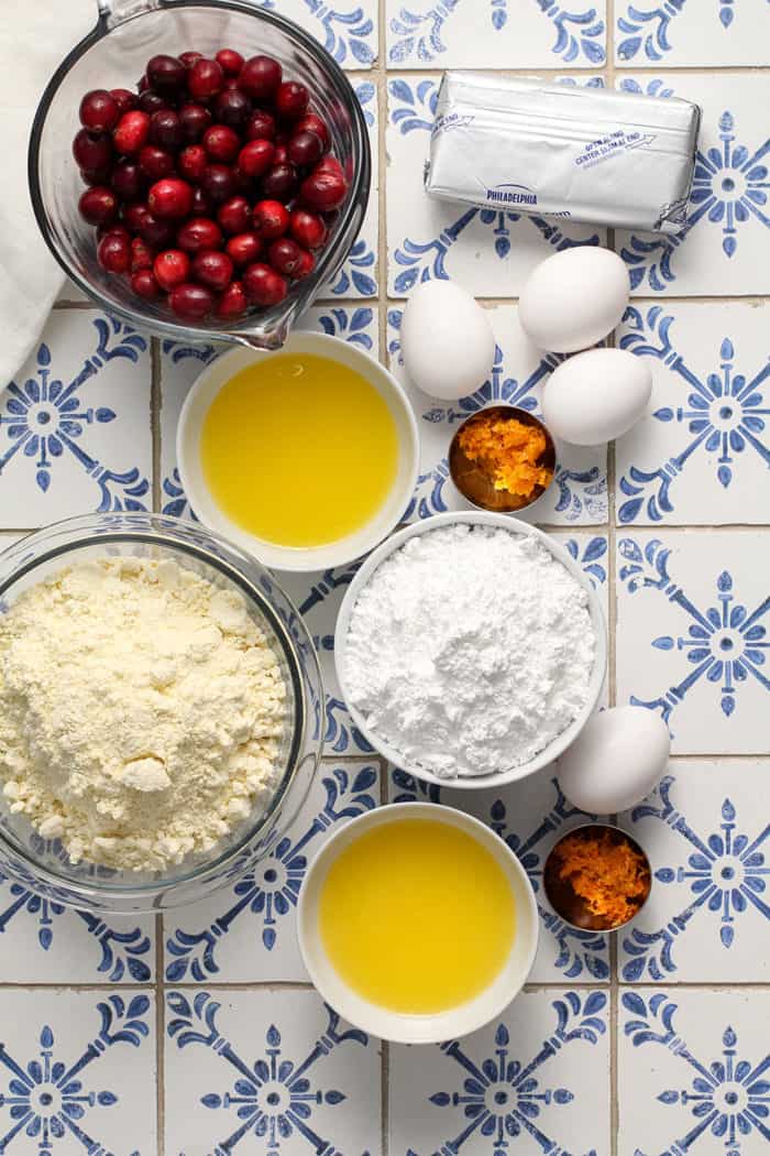 Ingredients for gooey butter bars arranged on a blue and white tiled countertop