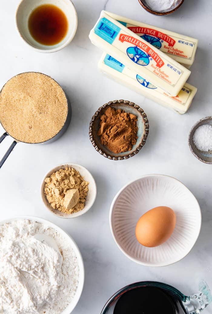 Ingredients for frosted ginger cookies arranged on a white countertop