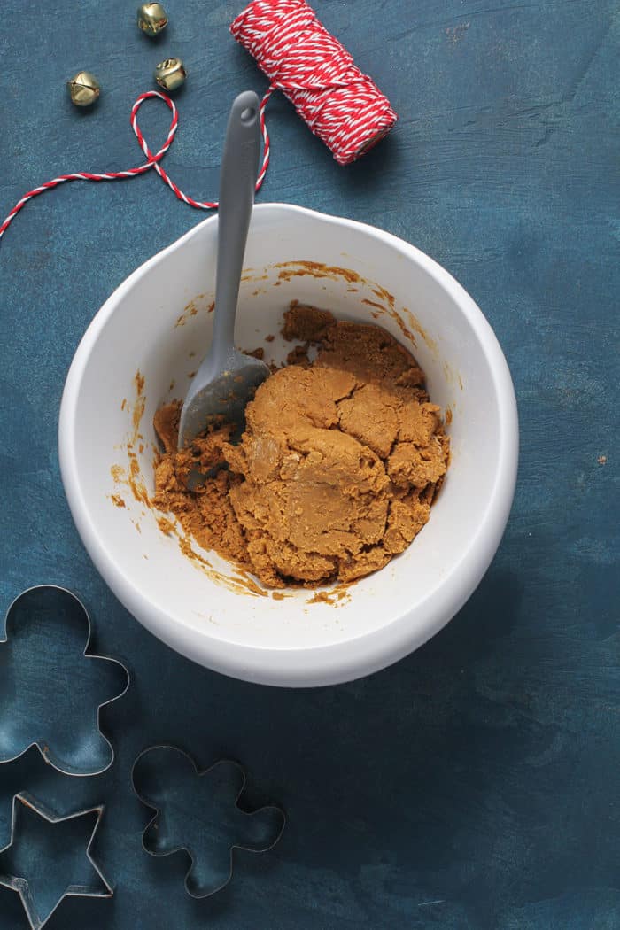 Dough for gingerbread cookies in a white mixing bowl