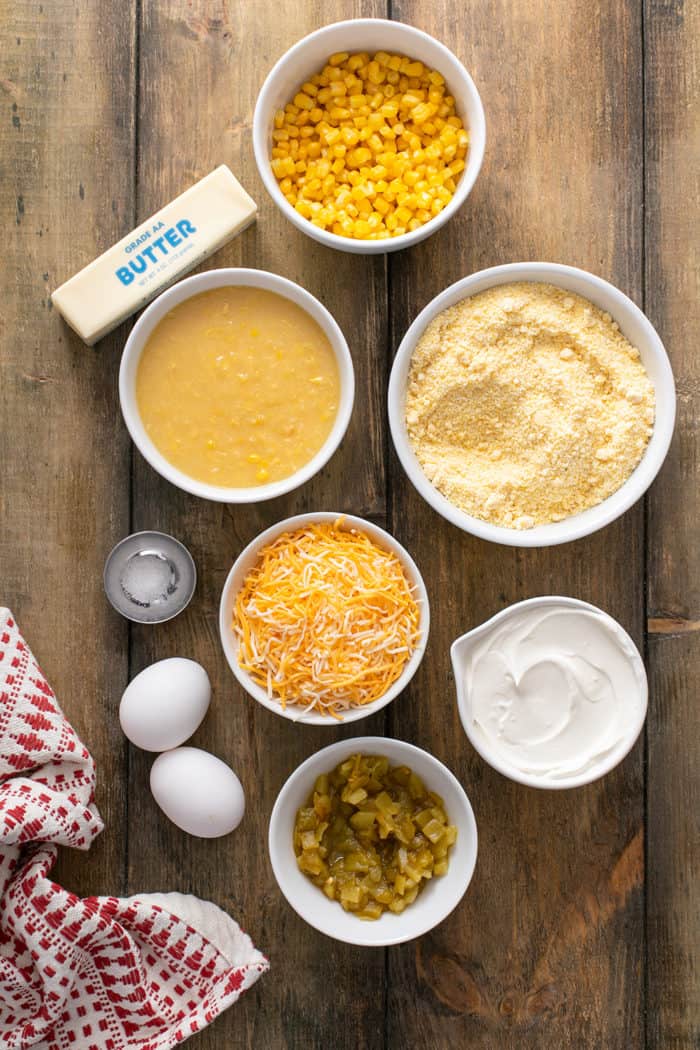 Ingredients for green chile corn casserole arranged on a wooden table