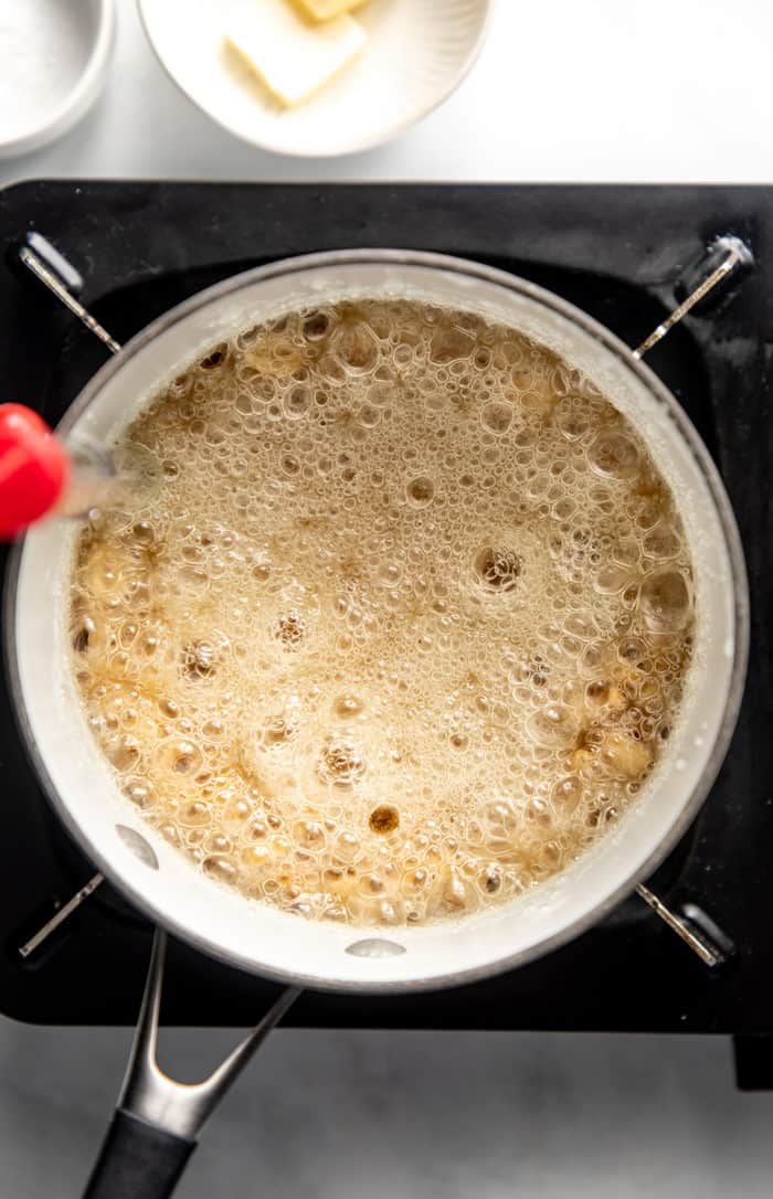 Peanut brittle halfway cooked in a saucepan