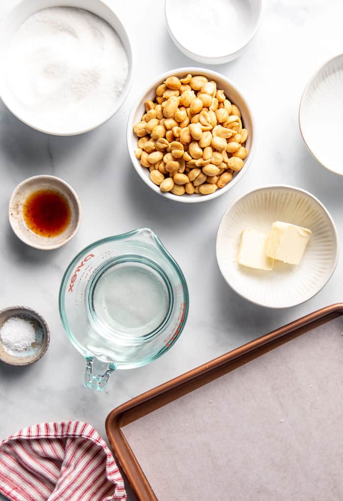 Peanut brittle ingredients arranged on a white countertop
