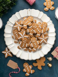 White platter piled high with cutout gingerbread cookies