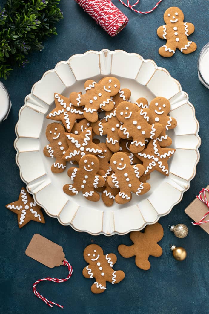 White platter piled high with cutout gingerbread cookies