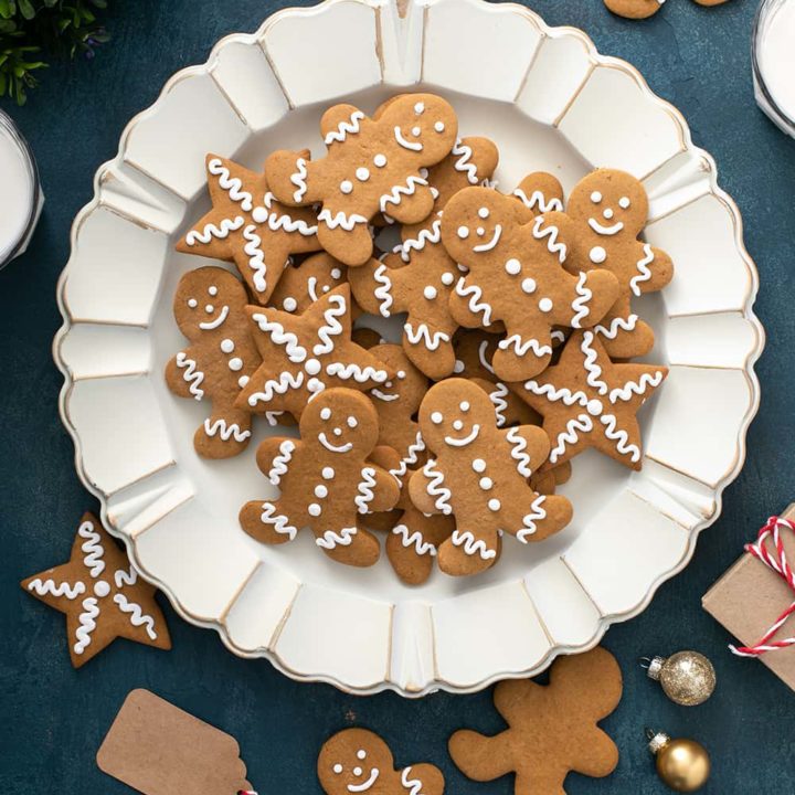 White platter piled high with cutout gingerbread cookies