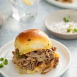 Philly cheesesteak slider on a white plate