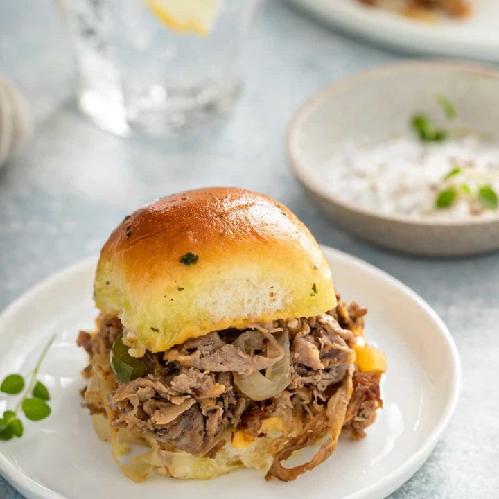 Philly cheesesteak slider on a white plate