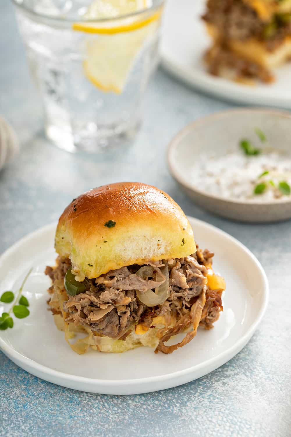 Philly cheesesteak slider on a white plate