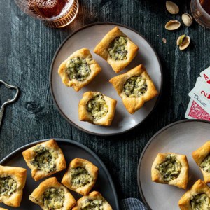 Spinach artichoke bites arranged on a variety of plates