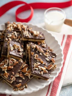 Saltine toffee stacked on a white platter