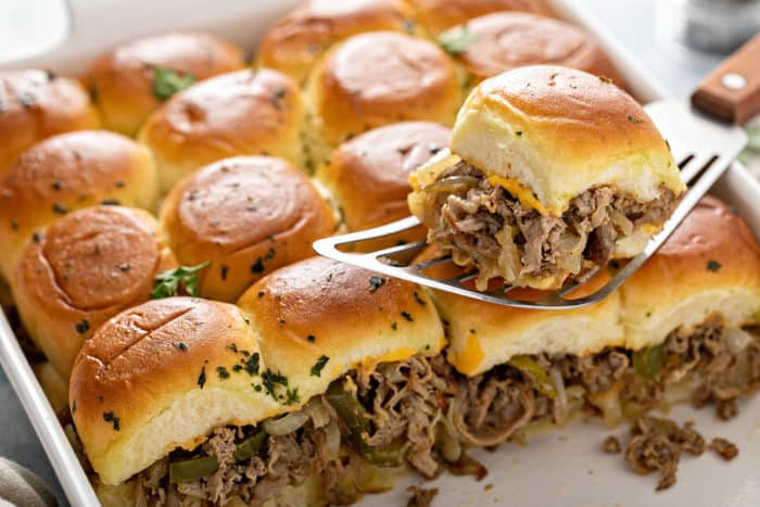 Spatula serving up a philly cheesesteak slider