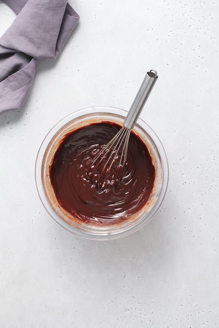 Bowl of chocolate ganache set on a marble countertop