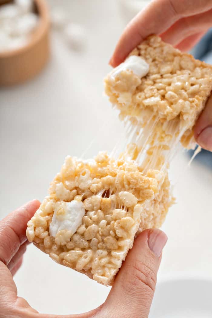 Hand pulling apart a classic rice krispie treat