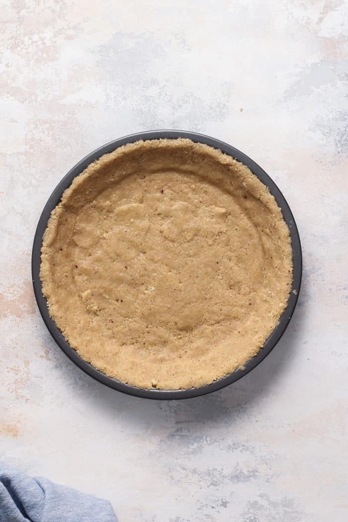 Baked shortbread cookie pie crust in a metal pie plate