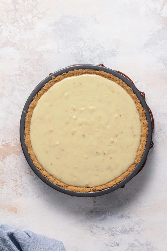 Chilled coconut cream pie ready for whipped cream topping set on a light colored countertop