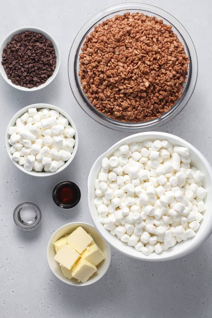Ingredients for chocolate rice krispie treats arranged on a white countertop