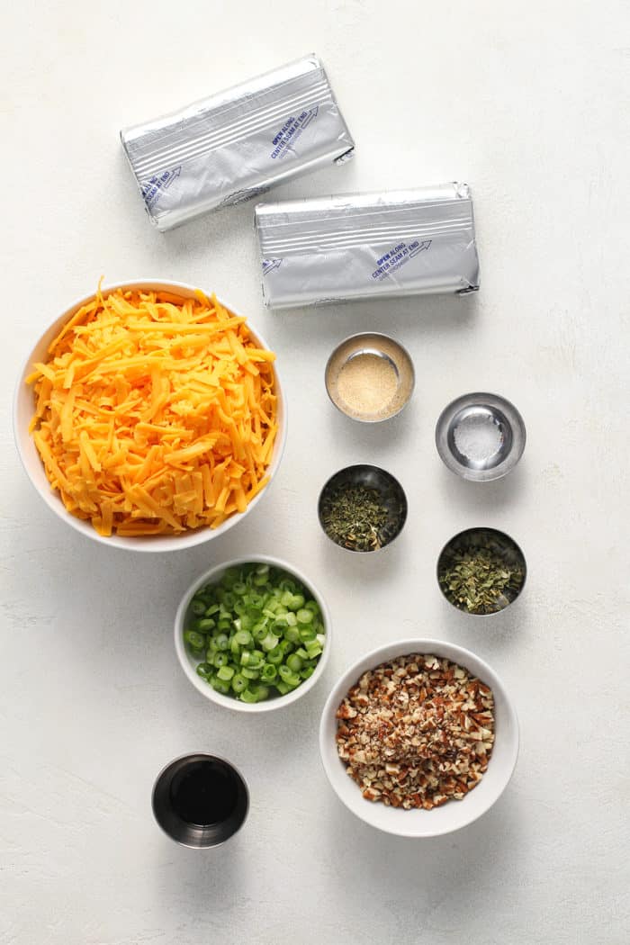 Ingredients for a classic cheese ball recipe arranged on a light-colored countertop
