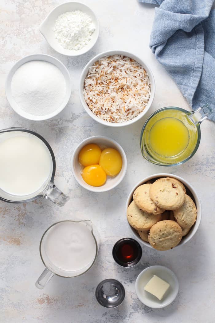 Ingredients for coconut cream pie arranged on a light colored countertop