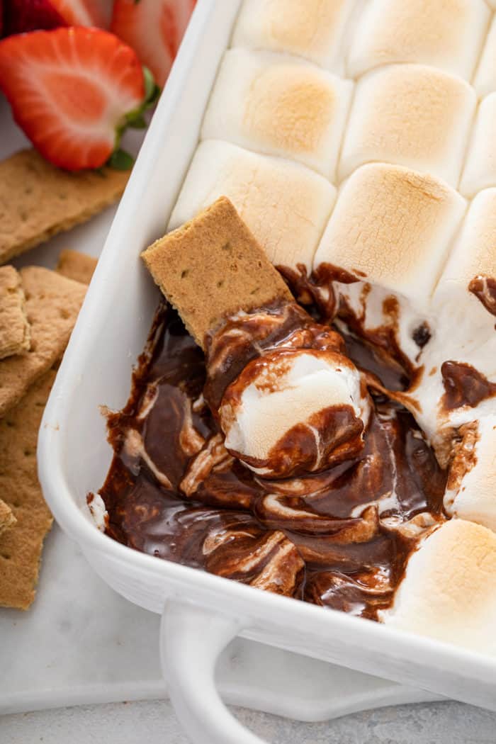 Graham cracker set into a pan of s'mores dip