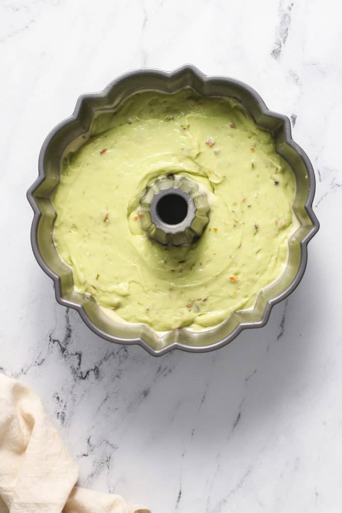 Pistachio pudding cake batter in a greased bundt pan