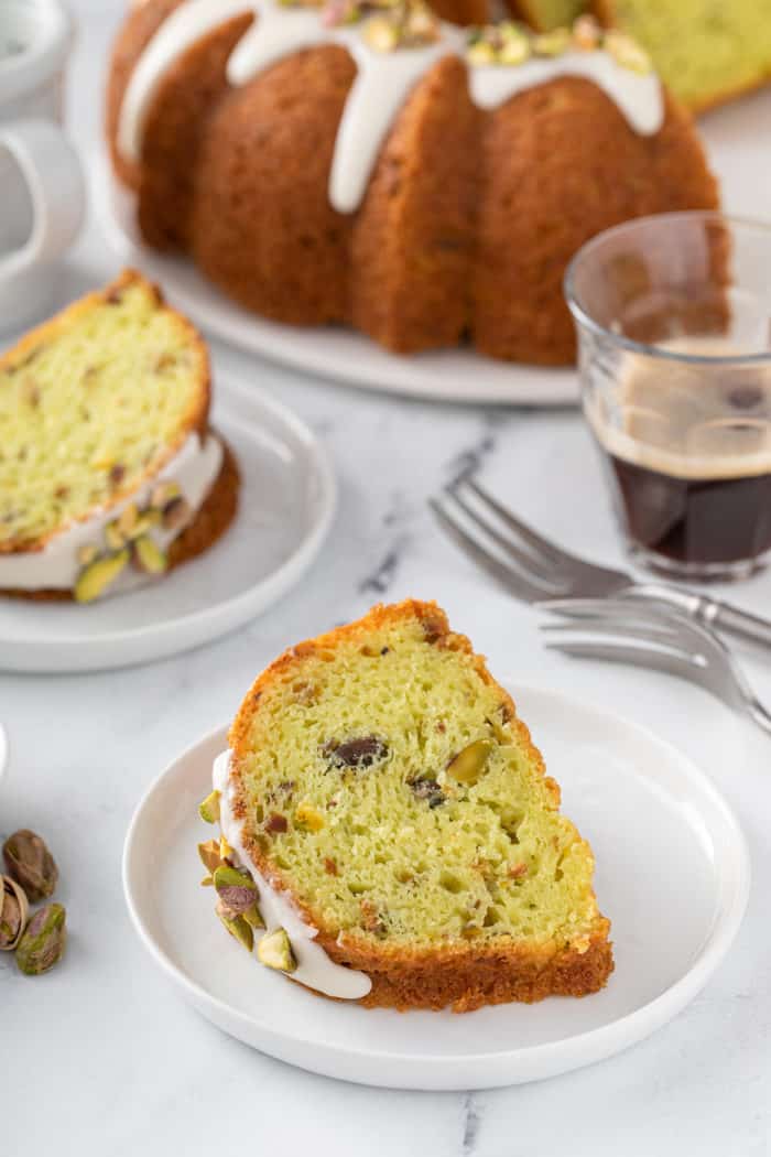 Slice of pistachio pudding cake set on a white plate