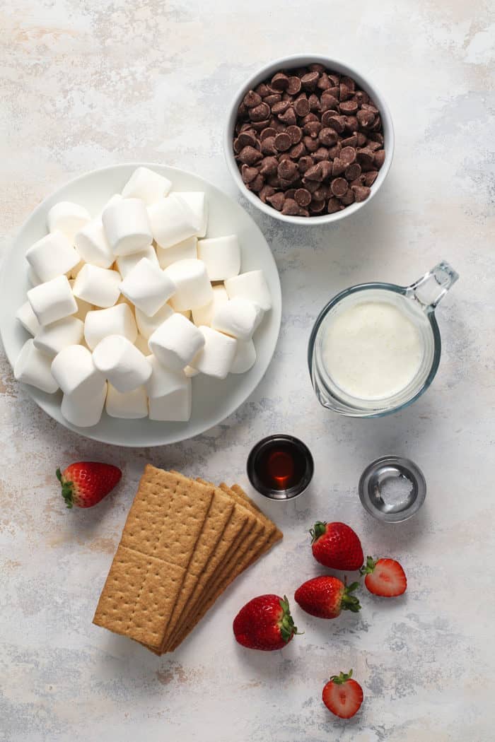 S'mores dip ingredients arranged on a light colored countertop