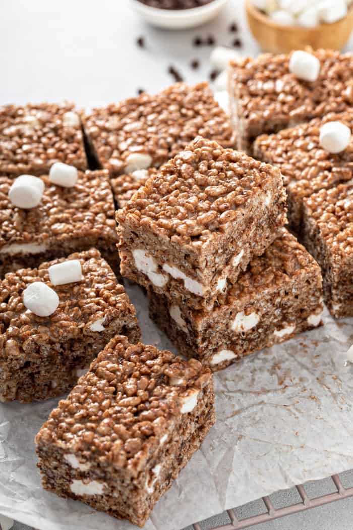 Chocolate Rice Krispie Treats arranged and stacked on a piece of parchment paper