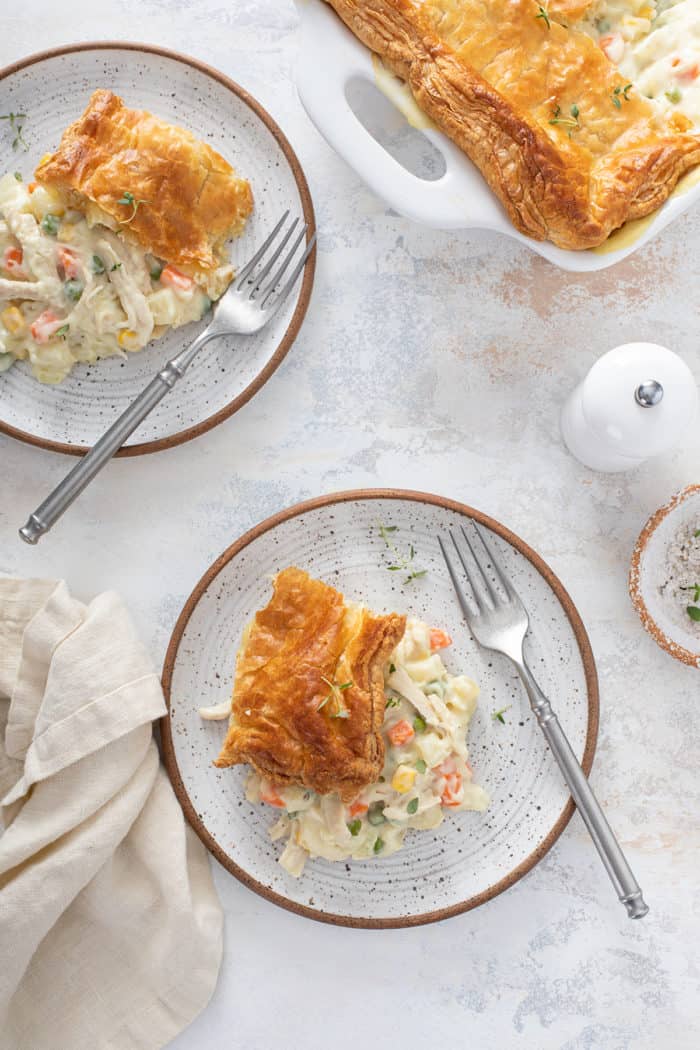 Overhead view of two plates of chicken pot pie casserole