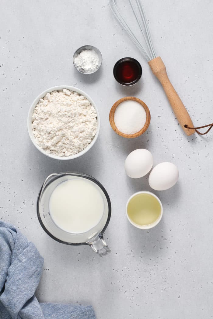 Bisquick waffle ingredients arranged on a light colored countertop