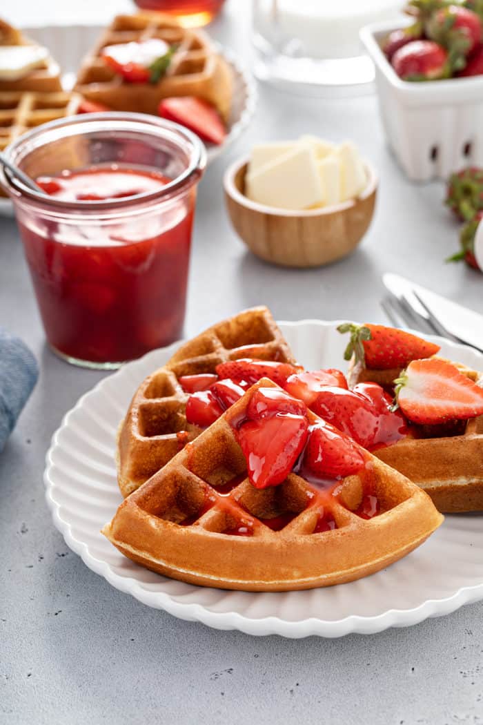 Plated bisquick waffles topped with homemade strawberry sauce
