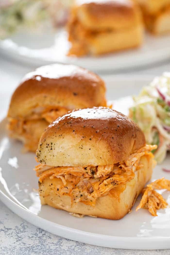 Close up of buffalo chicken slider on a white plate