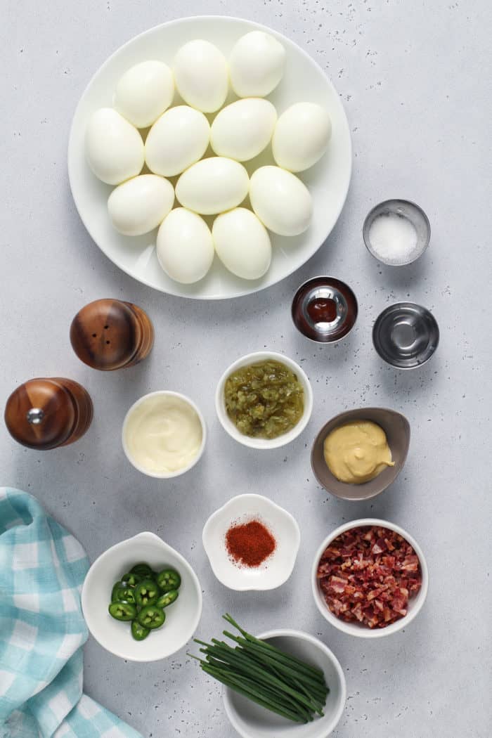 Deviled egg ingredients arranged on a white countertop