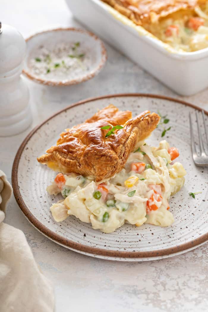 Serving of chicken pot pie casserole on a gray and white plate