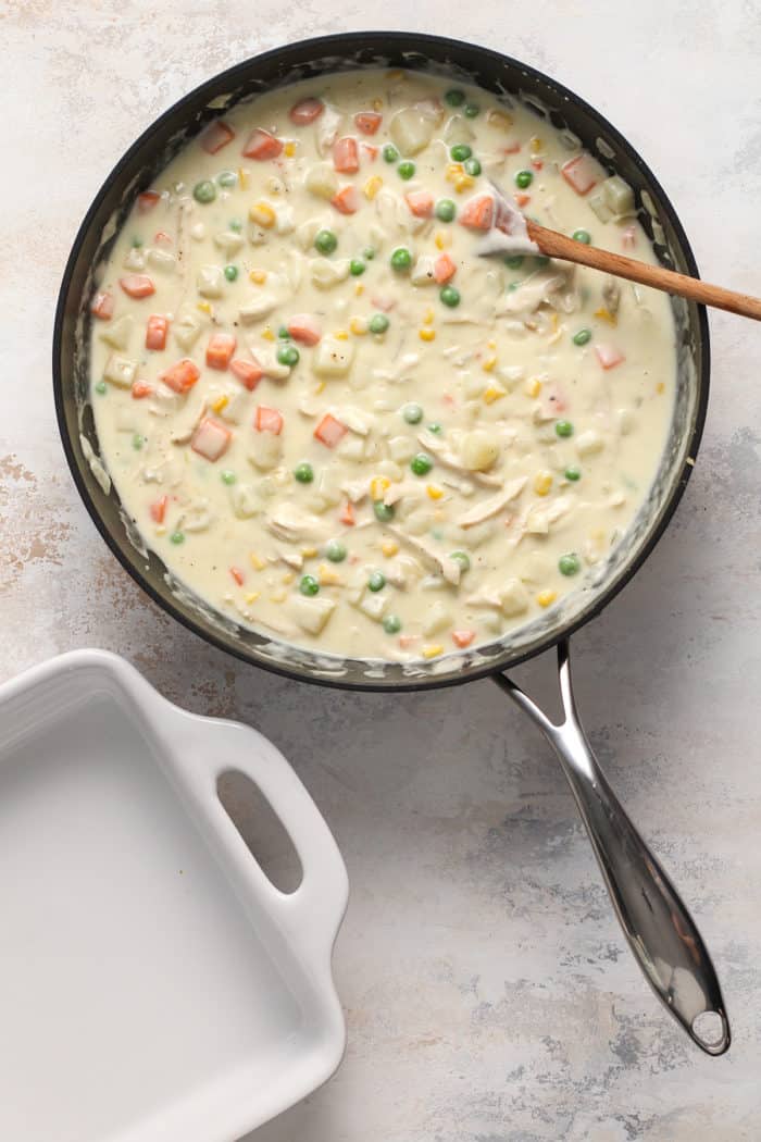 Chicken pot pie casserole filling in a black skillet